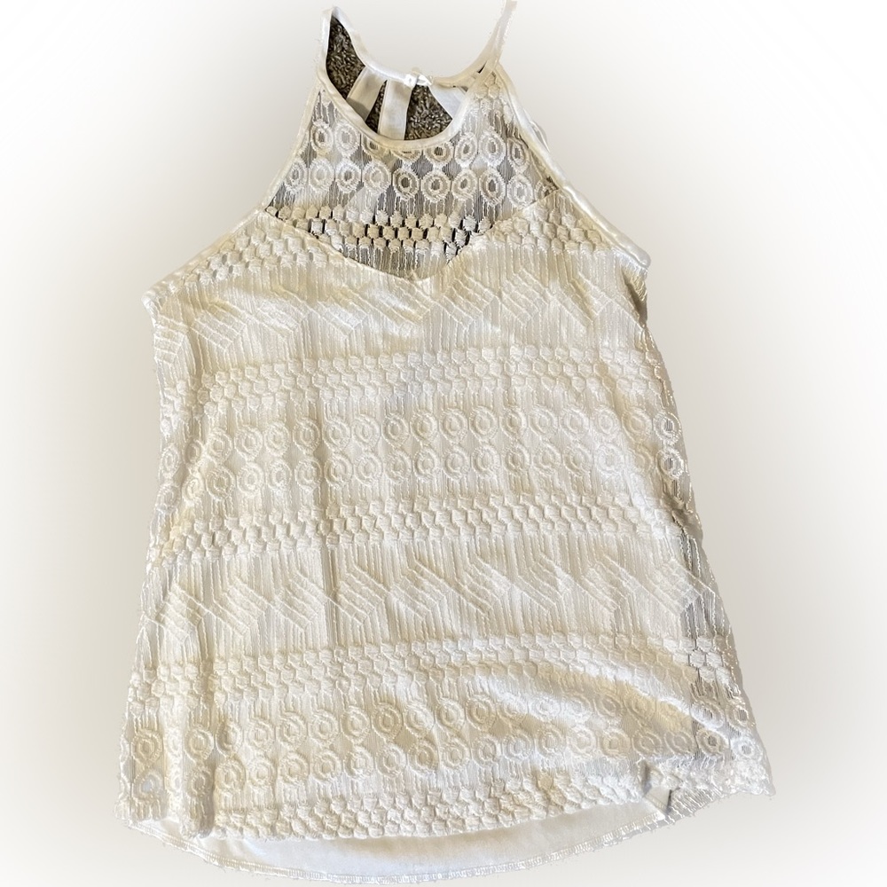 Solid white tank top satin tank top with patterned lace sewn over it.